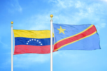 Fototapeta na wymiar Venezuela and Congo Democratic Republic two flags on flagpoles and blue sky