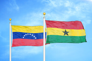 Venezuela and Ghana two flags on flagpoles and blue sky