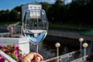 still life with a glass of white wine and external reflections