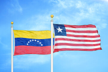 Venezuela and Liberia two flags on flagpoles and blue sky