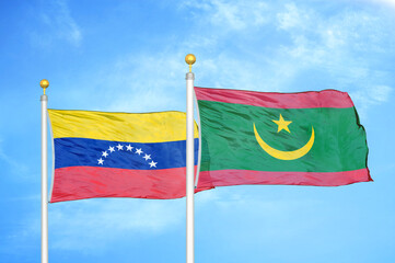 Venezuela and Mauritania two flags on flagpoles and blue sky