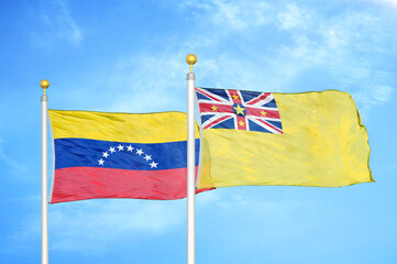 Venezuela and Niue two flags on flagpoles and blue sky