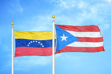 Venezuela and Puerto Rico two flags on flagpoles and blue sky