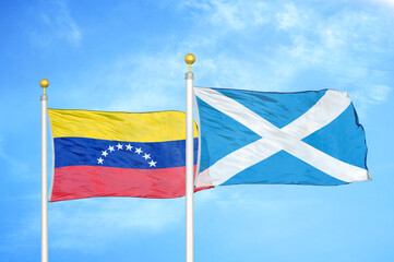 Venezuela and Scotland two flags on flagpoles and blue sky
