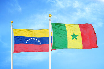Venezuela and Senegal two flags on flagpoles and blue sky