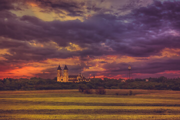 Fototapeta premium Victoria, KS USA - Panorama View of the Midwest Wheat Field Prairie and Cathedral of the Plains in Victoria Kansas USA Prairie in Sunset Sky Clouds
