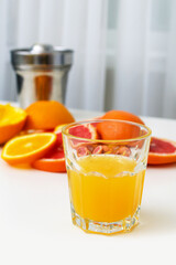 orange juice in a glass on a white table