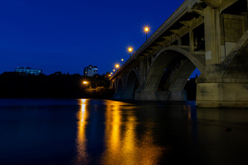 Fototapeta na wymiar A picturesque view of the Broadway Bridge and South Saskatchewan River in the City of Saskatoon late at night 