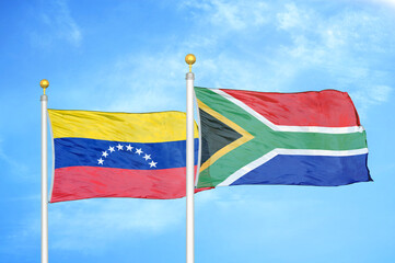 Venezuela and South Africa two flags on flagpoles and blue sky