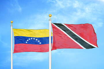 Fototapeta na wymiar Venezuela and Trinidad and Tobago two flags on flagpoles and blue sky
