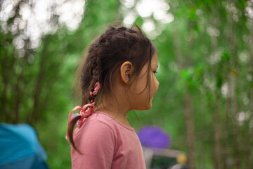 Girl 4 years old in the forest. Little girl of Asian appearance