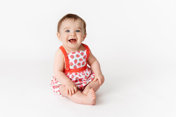 Cute smiling baby wearing strawberry outfit on white background