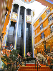 View into lobby or atrium on modern cruise ship liner or cruiseship with elevators and dramatic...