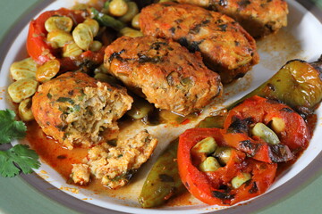 Fish meatballs in tomato sauce. Meatballs with a side dish of green beans and vegetables in tomato sauce 
close-up in a plate on the table. horizontal
