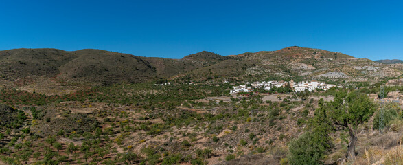 white facades town between mountains