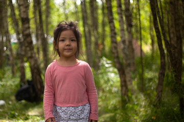 Girl 4 years old in the forest. Little girl of Asian appearance