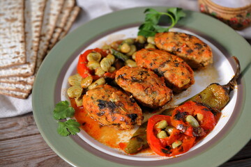 Fish meatballs in tomato sauce. Meatballs with a side dish of green beans and vegetables in tomato sauce 
close-up in a plate on the table. horizontal

