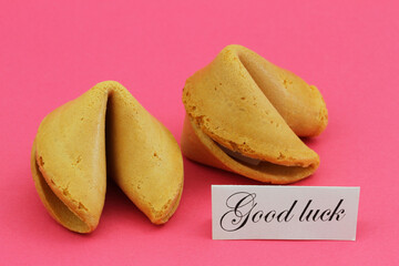 Good luck card with two Chinese fortune cookies on vivid pink background
