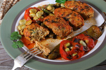 Fish meatballs in tomato sauce. Meatballs with a side dish of green beans and vegetables in tomato sauce 
close-up in a plate on the table. horizontal
