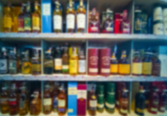 Blurred abstract background of shelf in supermarket. Alcohol showcase blurred background.