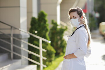 Female doctor or nurse wearing a face protective mask Covid19 healthcare concept