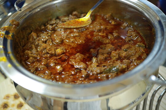South Indian dish spicy beef fry Kerala, India. side dish ghee rice, appam, parotta, puttu, bread and chappathi, Kerala cuisine ,Buffalo roast / Meat pepper fry with coconut. India spices cooking,