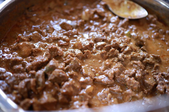 South Indian dish spicy beef fry Kerala, India. side dish ghee rice, appam, parotta, puttu, bread and chappathi, Kerala cuisine ,Buffalo roast / Meat pepper fry with coconut. India spices cooking,