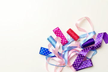 blue, red, brown polka-dot ribbons and spools of thread