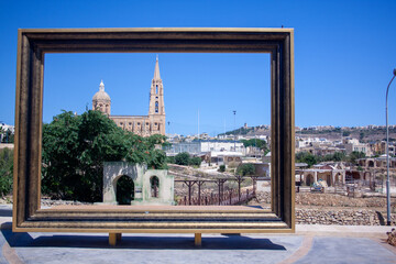 Ghajnsielem Parish Church on Malta (Gozo island) seen through a giant picture frame.