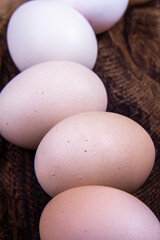 Native eggs are placed in a dish or basket or white cloth in order of color.