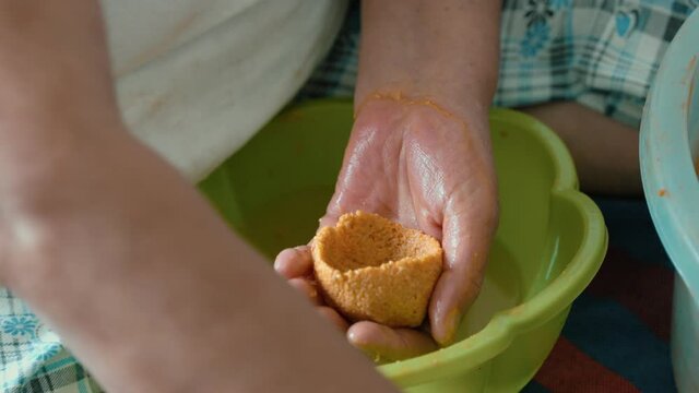 Traditional Turkish Food; Stuffed Meatballs, Turkish known as "icli kofte". Woman making Stuffed Meatballs at home.