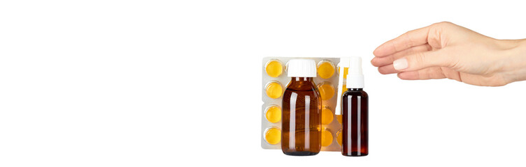 Throat ache pills in bister, spray and syrup with hand, isolated on white background. Copy space template, banner.