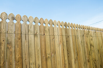 Installing a wooden fence on a dacha plot.