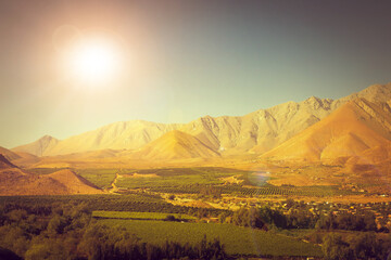 Chilean landscape with mountains and fields near Vicuña at sunset