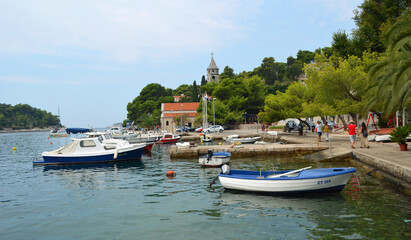 Fototapeta na wymiar Cavtat harbor with small boats and church.