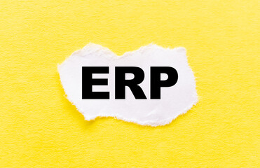 The INSCRIPTION ERP ON a WHITE piece of PAPER on a yellow background
