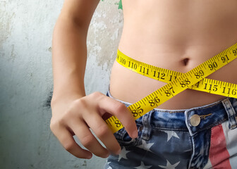 woman measuring her waist