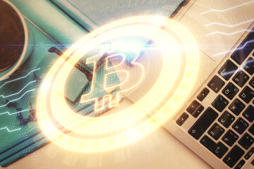 Blockchain theme hologram drawings over computer on the desktop background. Top view. Multi exposure. Concept of cryptoeconomy.