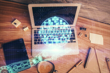 Blockchain theme hologram drawings over computer on the desktop background. Top view. Multi...