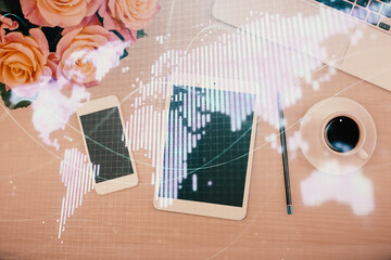 Double exposure of business theme hologram over desktop with phone. Top view. Mobile international...