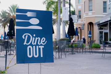 Dine Out Sign Near Outdoor Dining in Street