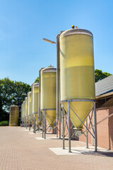 Row of dutch feed silos at cattle shed