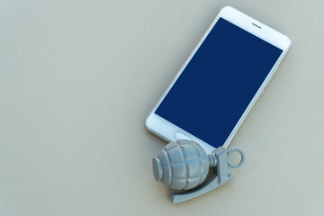 modern cell phone and dummy grenades. Selective focus. The concept of refusing to use gadgets....