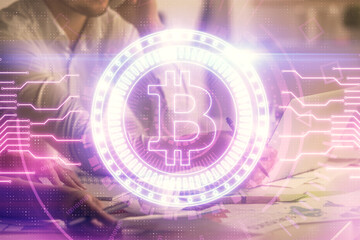 Double exposure of man and woman working together and crypto finance theme hologram. Blockchain business concept. Computer background.