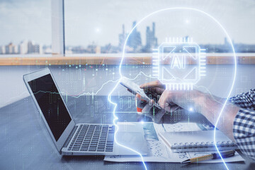 Double exposure of man's hand holding and using a digital device and brain hologram drawing. Data concept.