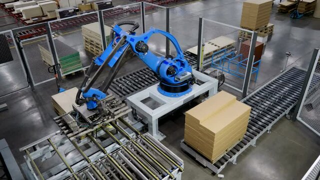Furniture factory. A modern automated machine packaging furniture parts in cartons. 4K