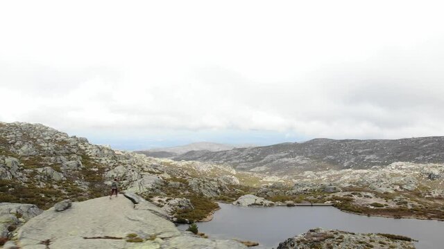 Aerial drone shot of Covao dos Conchos dam lake on rocky highlands of Serra da Estrela