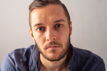 Fototapeta premium Portrait of Young Blond Hair Caucasian Male Looking at the Camera