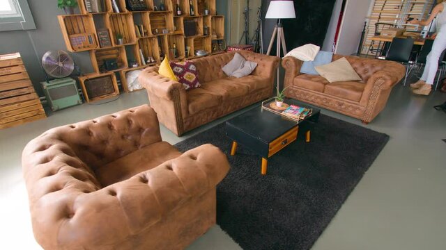 Photo studio with bookshelf and leather couch
