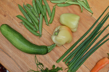 green peas, paprika,onion leafs on table 